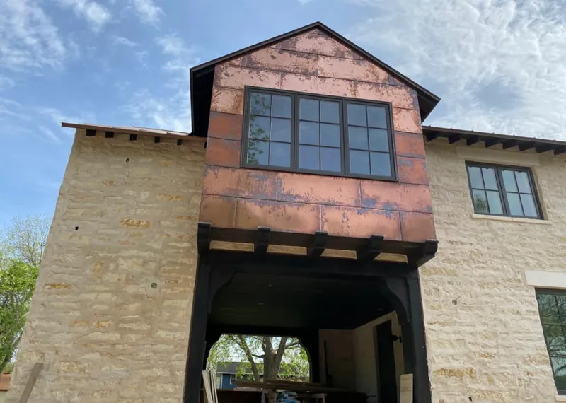Copper metal panel facade on a stone building for Roof Repair in Ridge Wood Heights